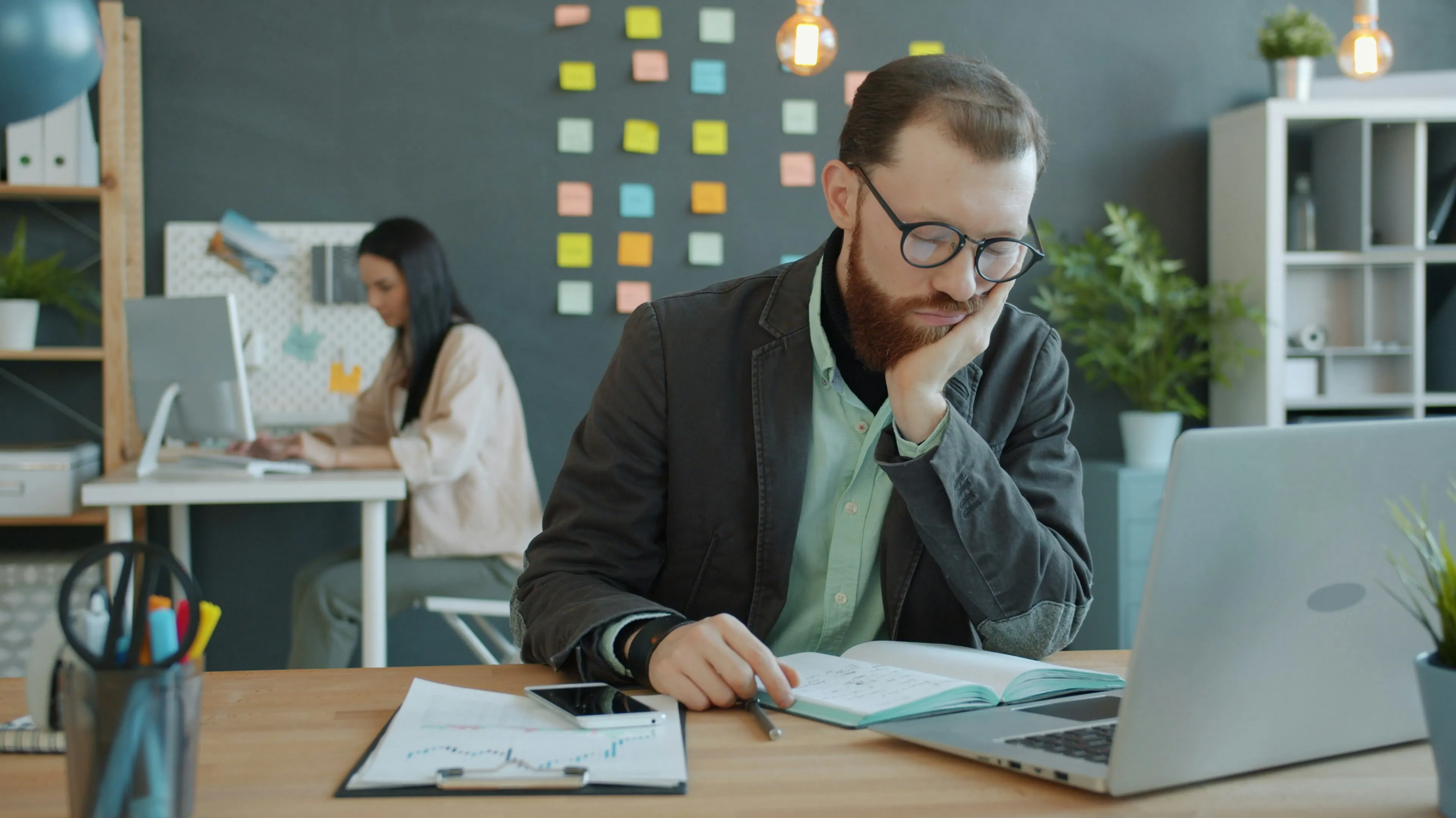 A person looking stressed while working on a computer