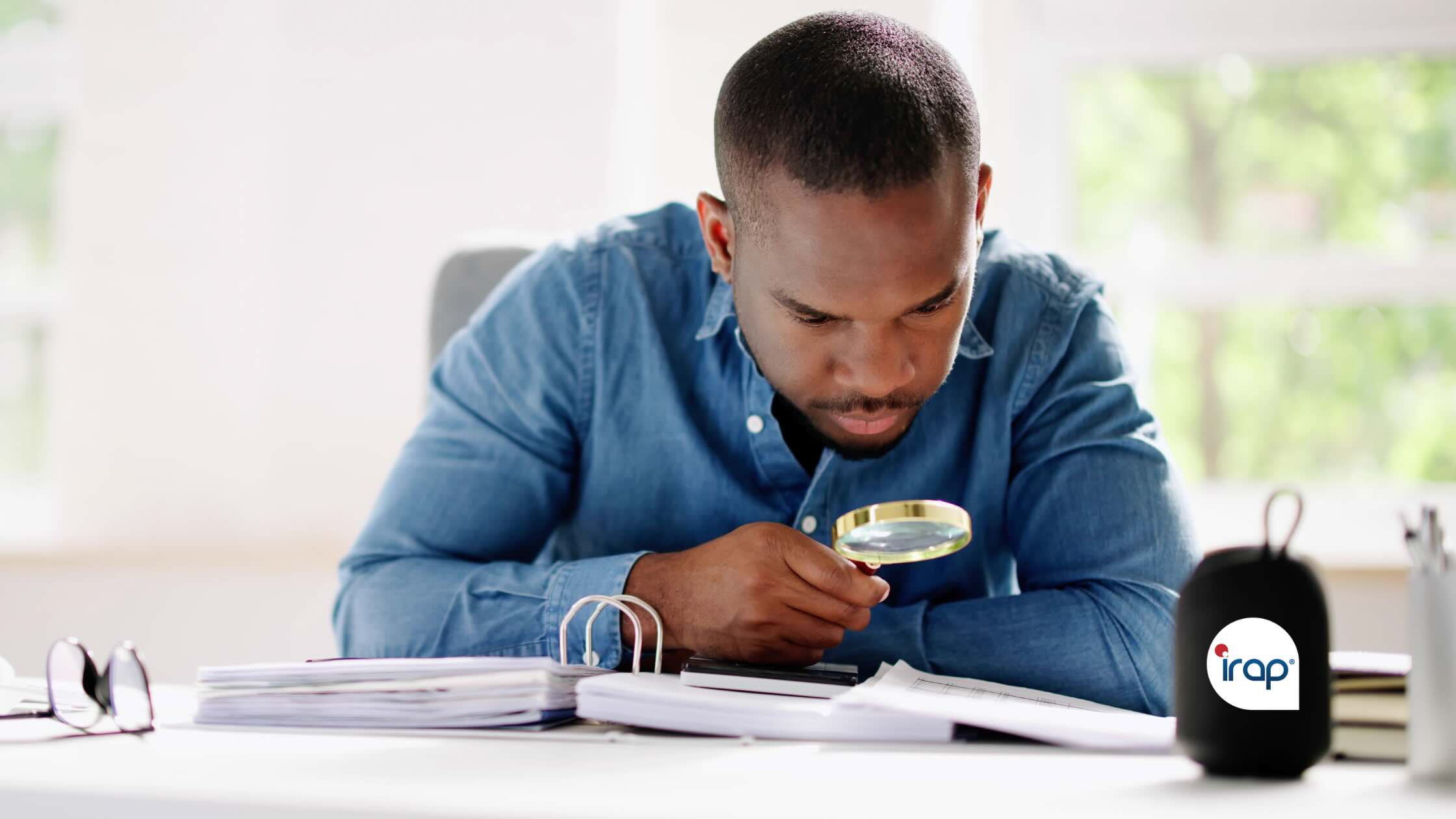 A person looking at a document using a microscope.